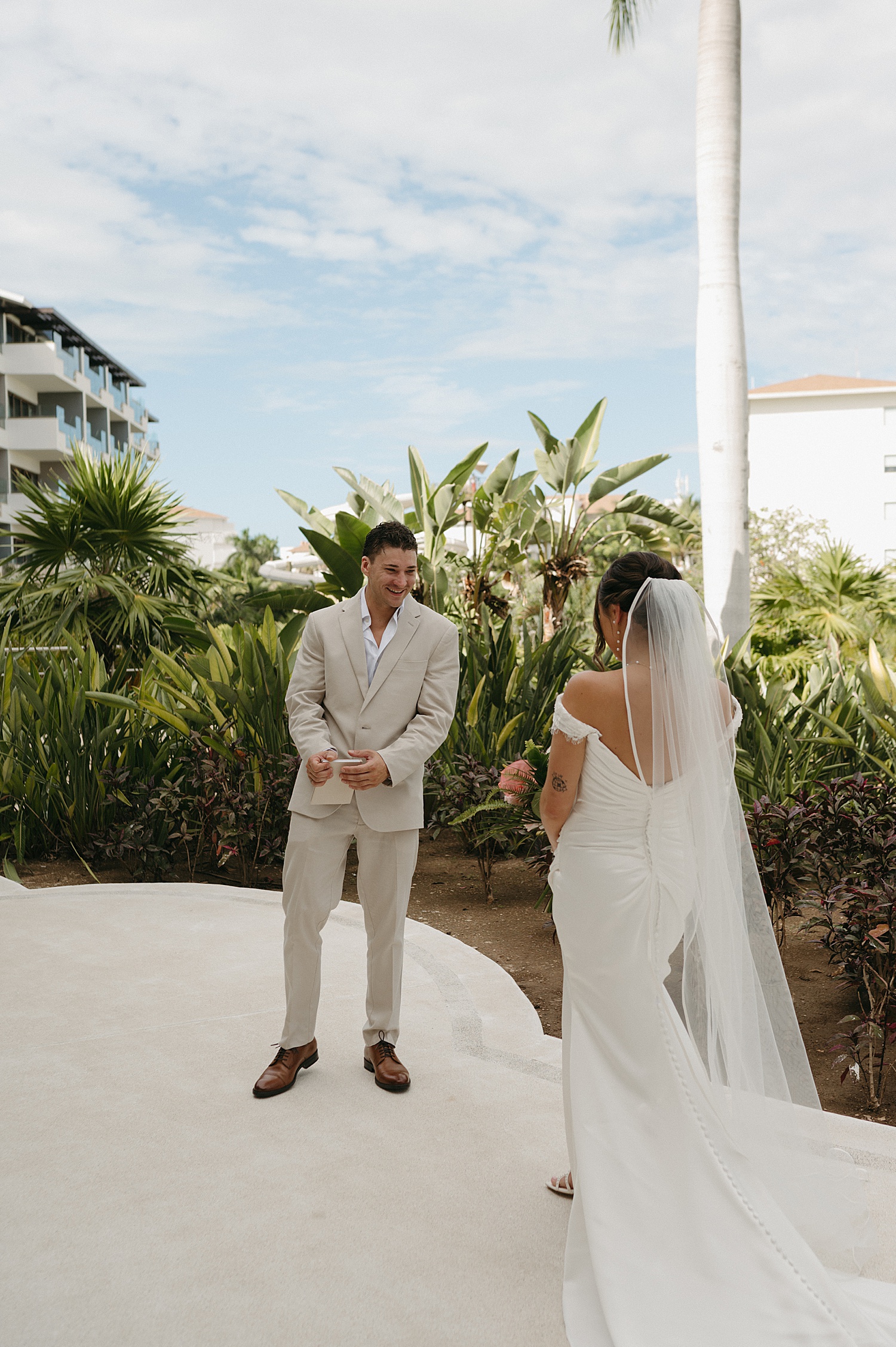 woman approaches her groom for first look outside by Thistle and Veil Photo