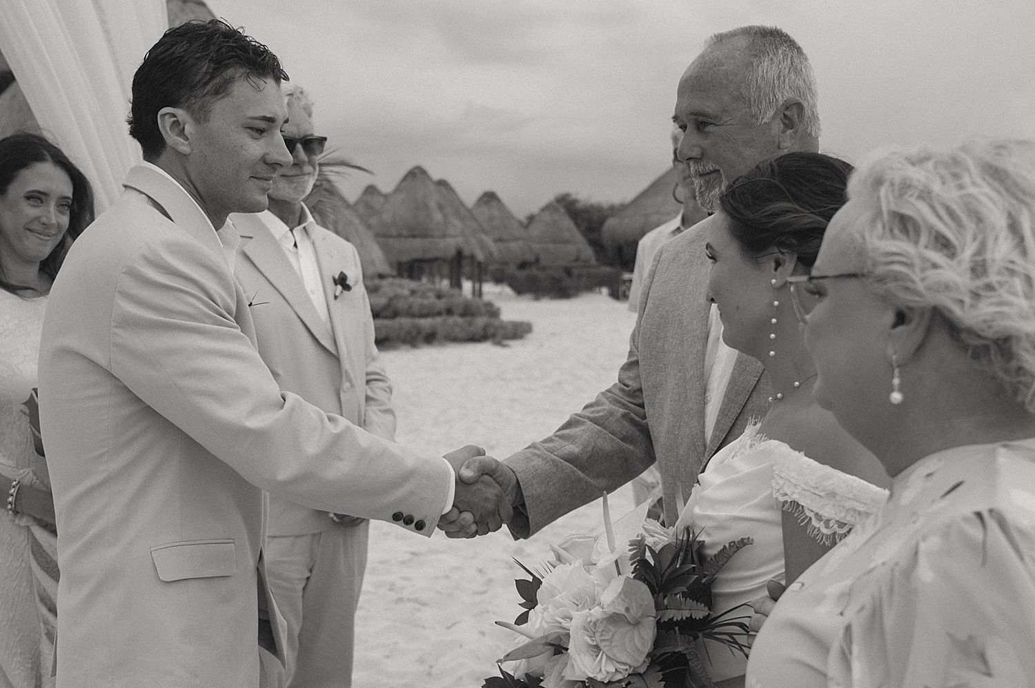 father shakes groom's hand during ceremony by Travel Elopement Photographer
