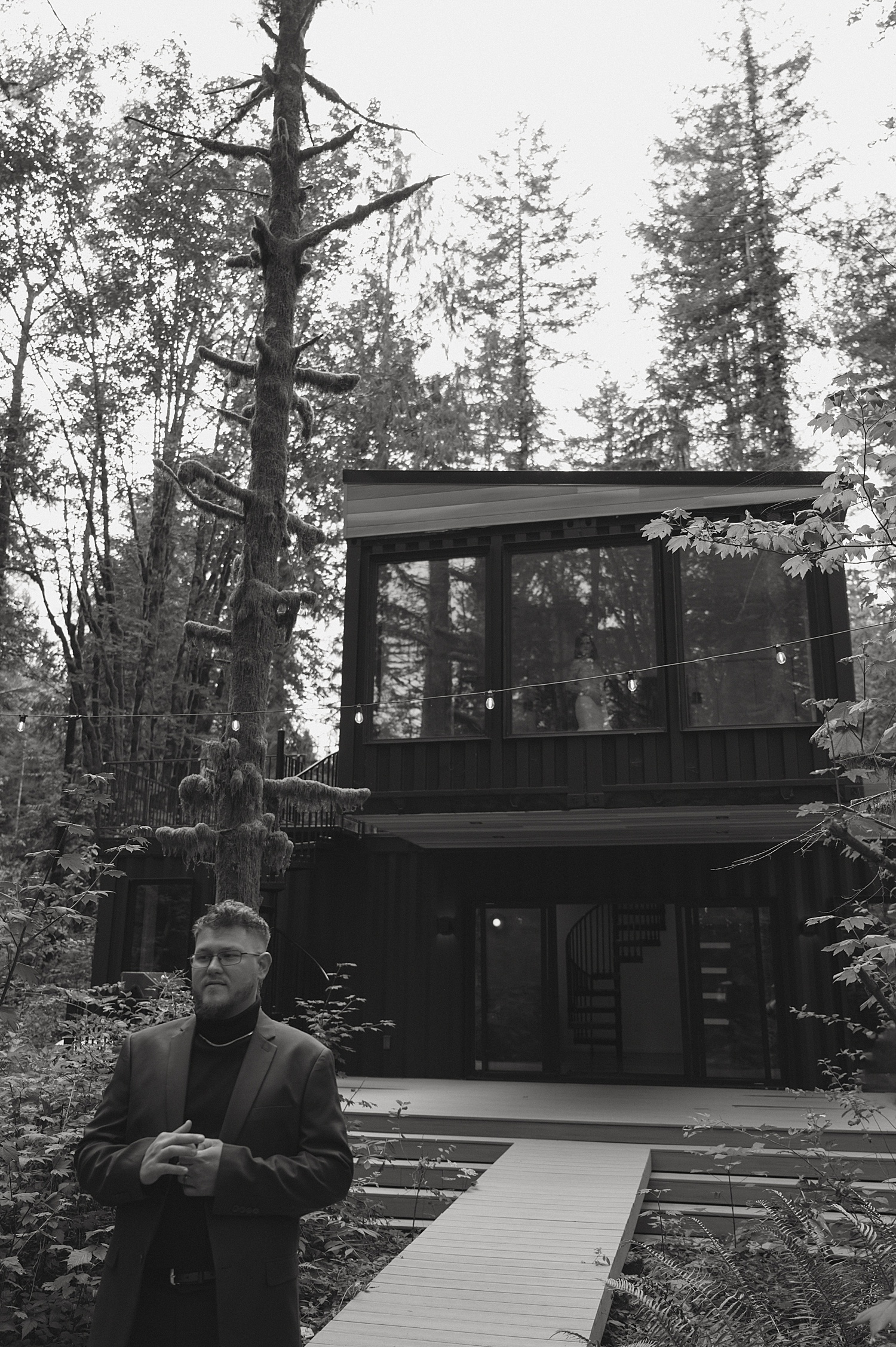 man stands in front of cabin for vow renewal
