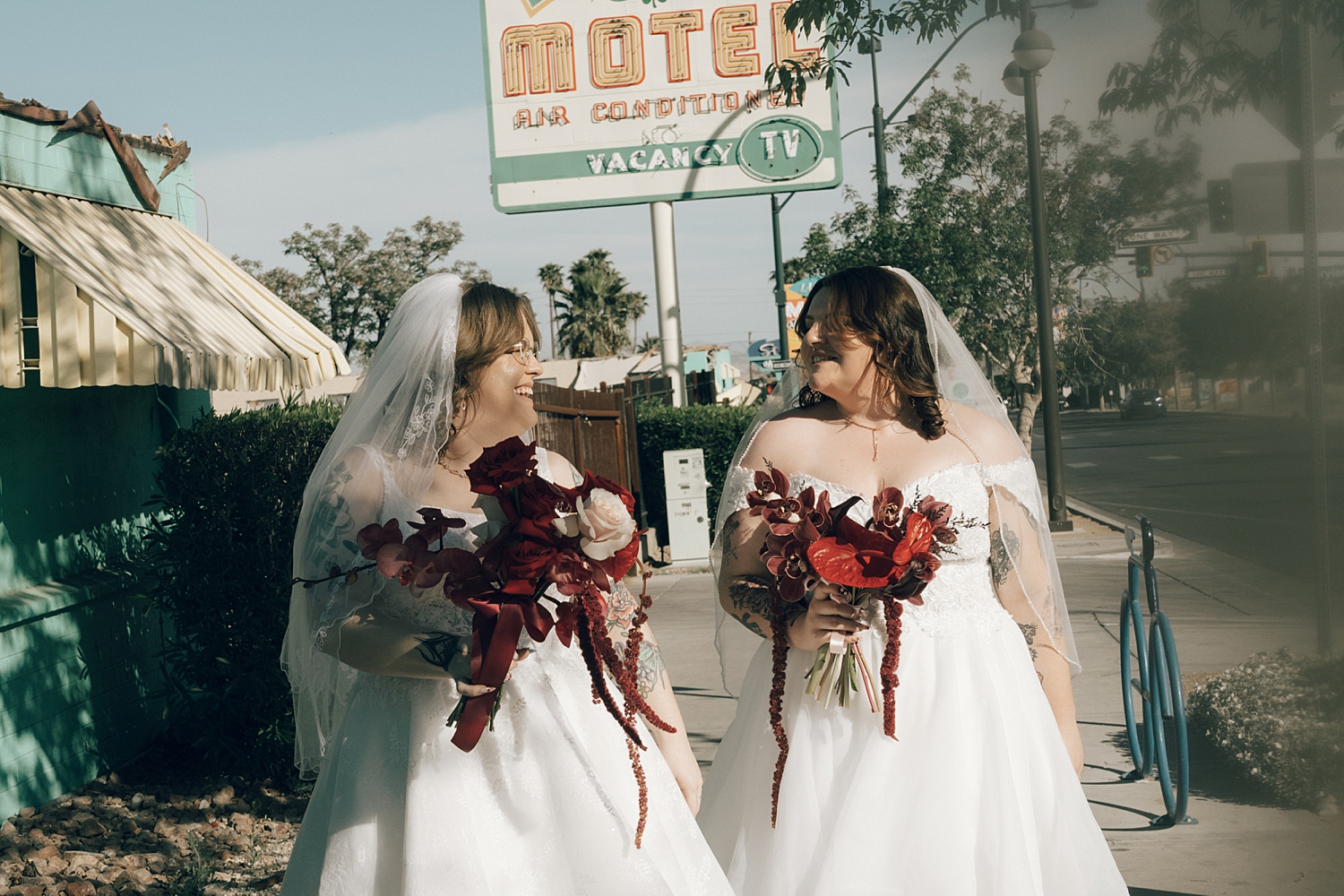 two women in wedding dresses walk on sidewalk before big day at Sure Thing Chapel