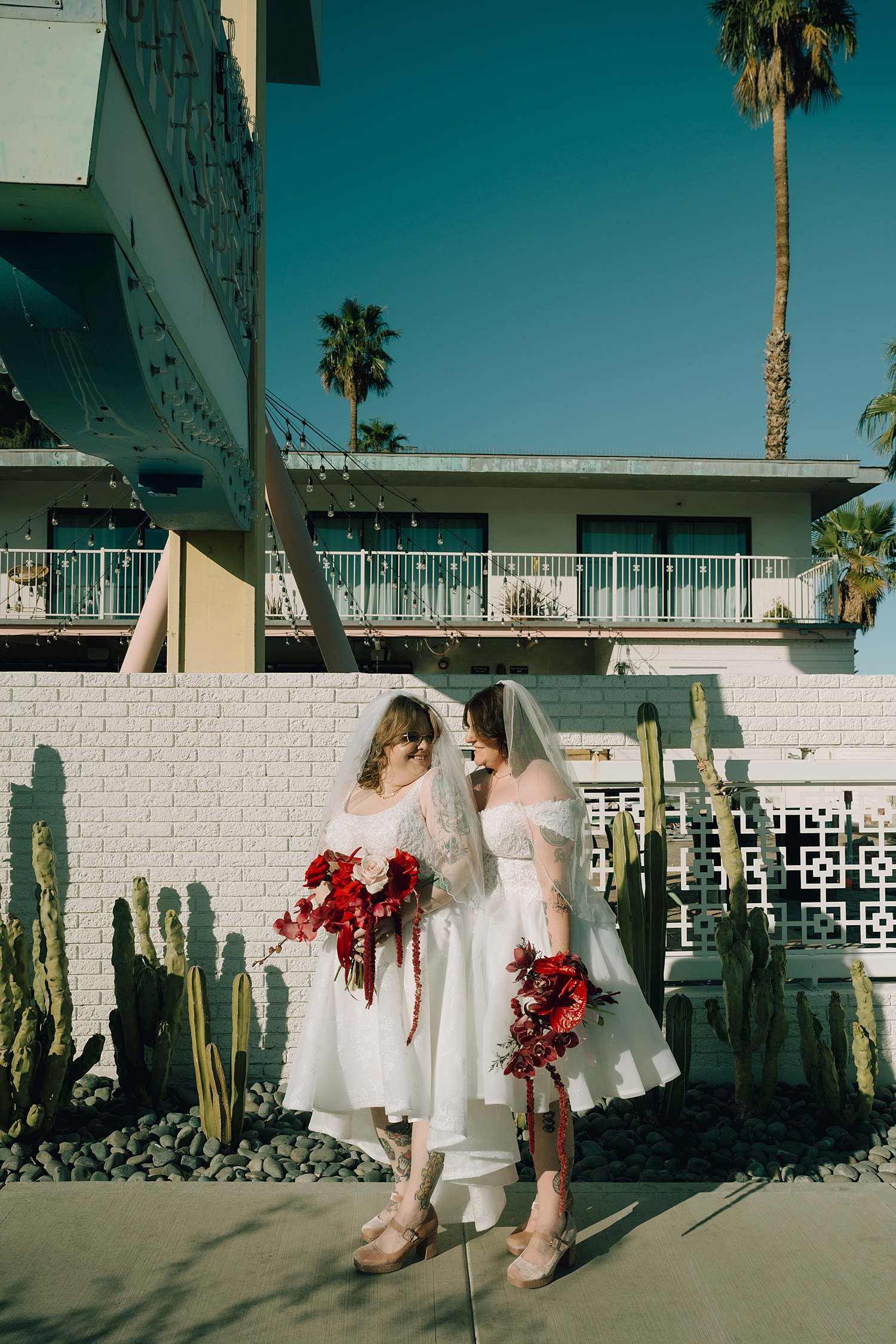 couple share a loving glance on sidewalk by Thistle and Veil Photo