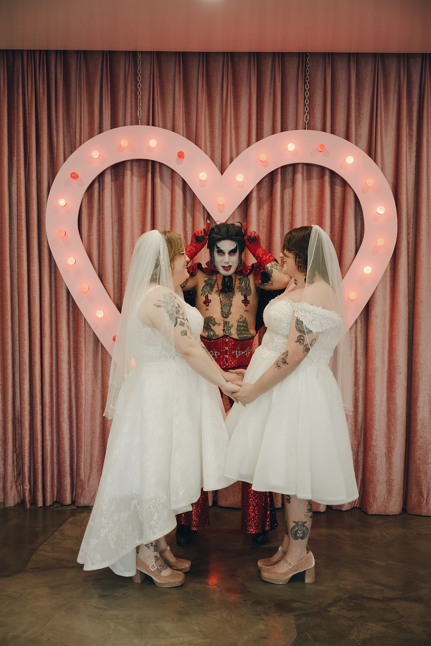 hellvis puts up devil horns during ceremony at sure thing chapel