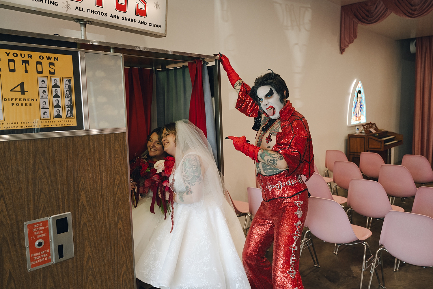 Hellvis points to brides in photo booth by Thistle and Veil Photo